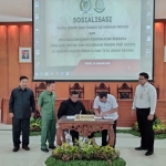Kajari Chandra Eka Yustisia dan Ketua DPRD Kab. Kediri (duduk di kursi roda) saat menandatangani MoU