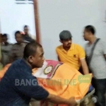Petugas saat mengevakuasi korban dari kamar hotel. foto: ERRI/ BANGSAONLINE