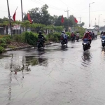 Tampak air luapan Kali Mangetan Kanal yang menggenangi Jalan Raya Sukodono.