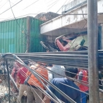 Truk Kontainer dan Mobil Ertiga dikerumuni warga usai tabrakan mengakibatkan pengemudi Ertiga tewas di tempat. foto: SYUHUD/BANGSAONLINE