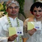 Raffi Ahmad dan Nagita Slavina, menunjukkan buku nikah setelah menunaikan Akad Nikah di Hotel Ritz Carlton, Jakarta, 17 Oktober 2014. TEMPO/Frannoto