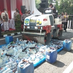 Plt Bupati Nganjuk, Marhaen Jumadi, saat menjalankan mobil penggilas untuk menghancurkan ribuan botol miras.