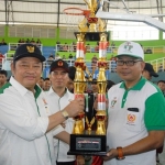 JUARA: Bupati Saiful Ilah didampingi Ketua KONI, M Franki Effendi menyerahkan piala juara umum Porkab 2016, di GOR Delta, pada 17 Desember 2016 lalu. Foto: ist