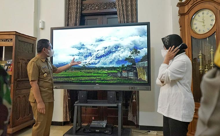 Mensos Tri Rismaharini mendengarkan pemaparan Bupati Lumajang Thoriqul Haq tentang dampak aktivitas Gunung Semeru tiga hari lalu yang mengeluarkan APG.