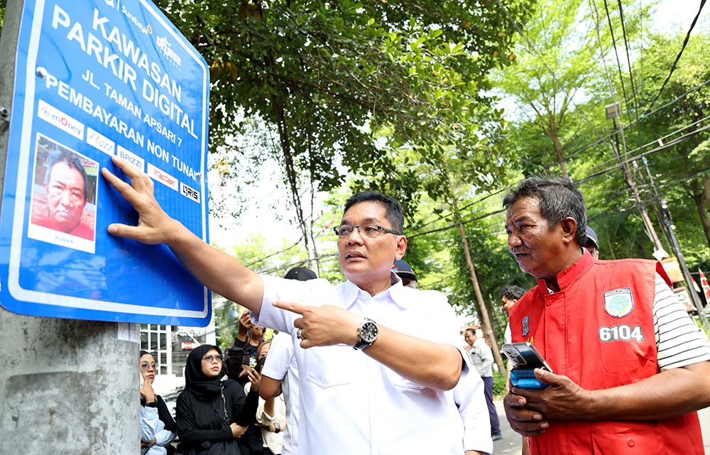 Pemasangan dilakukan melalui metode foto langsung di lokasi, kemudian dicetak, dan ditempel pada rambu kawasan parkir digital. Foto: Hms