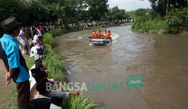 Petugas menyisir sungai tempat korban tenggelam. foto: rony suhartomo/ BANGSAONLINE