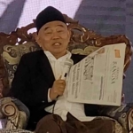 Prof Dr KH Asep Saifuddin Chalim, MA, saat membaca berita HARIAN BANGSA dalam acara Haflah Akhirus Sanah Madrasah Bertaraf Internasional (MBI) Pondok Pesantren Amnatul Ummah Pacet Mojokerto, Sabtu (21/5/2025). Foto: bangsaonline