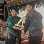 Dandim 0809 Kediri Letkol Inf. Arif Setiawan saat menyerahkan tokoh Bima kepada Ki Dalang Disik Wibisono sebelum pertujukan dimulai. Foto: MUJI HARJITA/ BANGSAONLINE.com