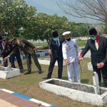 Wabup Mohni bersama forkopimda saat tabur bunga di makam pahlawan.