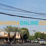 Kabel semerawut di perempatan Giri, Kecamatan Kebomas, Gresik. Foto: SYUHUD/BANGSAONLINE
