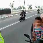 Seorang ibu dan anaknya dihentikan polisi karena tak memakai helm.