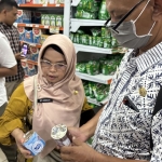TPID Kabupaten Tuban saat memeriksa kaleng susu yang kemasannya rusak atau penyok. Foto: Suwandi/BANGSAONLINE