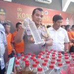 Kapolres Mojokerto Kota AKBP Bogiek Sugiyarto menunjukkan barang bukti miras yang diamankan.