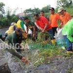 KONKRET: Pj Bupati Sidoarjo Jonathan Judianto turun ke sungai untuk membersihkan sungai sebagai aksi peduli lingkungan Sidoarjo Bebas Banjir. foto: musta