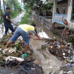 Antisipasi bencana banjir, Pemerintah Desa (Pemdes) Duri, Kecamatan Slahung, Kabupaten Ponorogo mengajak masyarakat dan pemuda setempat untuk kerja bakti membersihkan saluran air (selokan) hingga sungai yang berada di jalan poros kabupaten, Minggu (7/3/2021). (foto: ist)