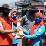 Pengurus Himpaudi Kota Batu saat membagikan bingkisan kepada penarik andong di Alun-Alun Batu.