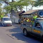 Kapten Inf. Edi Suryanto langsung mengambil pimpinan dalam giat pembagian masker dan penyemprotan disinfektan di sejumlah jalan di Pasuruan.