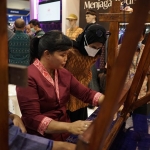 Istri Bupati Sekadau, Magdalena Susilawati Aron, didampingi Ketua Dekranasda Kota Kediri, Ferry Silviana Abu Bakar, saat mencoba alat tenun. Foto: Ist