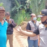 Wakapolsek Mojo, Iptu Sigit Rahmanto, S.H. (kanan) dan Kades Blimbing, Djoe Ari saat berada di lokasi tanah longsor. foto: MUJI HARJITA/ BANGSAONLINE