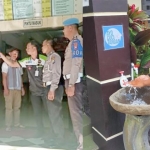 Ipda Hartawan, Kanit Regident Polres Batu saat mengecek suhu tubuh salah seorang pemohon SIM (foto kiri). Serta salah satu pemohon SIM saat memanfaatkan sarana cuci tangan.