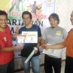 Taufik, Sekretaris PWI Malang Raya, saat menyerahkan tali asih uang pembinaan kepada juara turnamen bulutangkis antar wartawan se-Kota Malang, di Graha Tirta Kota Malang, Sabtu (11/11). Foto: IWAN IRAWAN/BANGSAONLINE