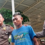Joki drag race Aditya alias Ucil ditangkap di Pasuruan dan dibawa ke Polresta Sidoarjo. Ucil diapit petugas Satlantas Polresta Sidoarjo 