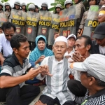 Salah satu warga penghuni yang terduduk lemas mengetahui rumahnya dibongkar.