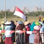 Para petani Tlogowaru melakukan upacara Kemerdekaan RI di sawah.