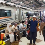 Suasana naik turun penumpang di stasiun kereta api.