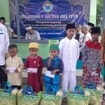 
Ketua IKA PMII Situbondo saat foto bersama dengan anak yatim penerima santunan.