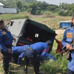 Petugas Damkar Gresik saat evakuasi pikap yang terperosok di pekarangan. Foto: Ist