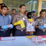 Kapolres menunjukkan barang bukti uang palsu yang diamankan dari warga Jember.