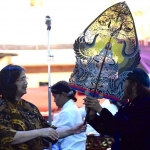 Pj Wali Kota Kediri, Zanariah, saat menyerahkan gunungan wayang kepada Ki Rudi Gareng. Foto: Ist