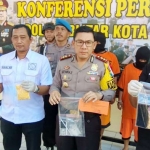 Petugas saat menunjukkan barang bukti hasil penangkapan.