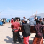 Jenazah warga Dusun Legundi, Desa Kepuh Legundi, Kecamatan Tambak, Pulau Bawean saat diturunkan dari kapal. foto: SYUHUD/BANGSAONLINE