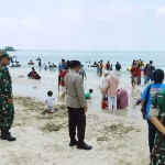 Personel Polres dan Kodim 0817/Gresik saat menjaga wisatawan yang tengah berlibur di Pantai Dalegan. Foto: Ist.