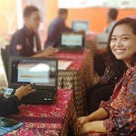 Nyonya Wenda A. H Lawitang, Ketua Persit KCK Kodim 0801 Pacitan, saat mengecek data dirinya dalam daftar pemilih saat pameran GMHP di KPU Pacitan. (Yuniardi Sutondo/BO)