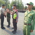Kapolres Pasuruan AKBP Raydian Kokrosono saat menyematkan tanda dimulainya operasi sekaligus pengamanan Pileg dan Pilpres mendatang. Foto: ANDY F/BANGSAONLINE