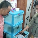 Pelaku (kiri) dengan pengawalan petugas saat menunjukkan barang-barang hasil curian. Foto: Ist