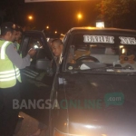 Petugas memeriksa satu per satu mobil beserta penumpangnya. foto: ZAINAL ABIDIN/ BANGSAONLINE