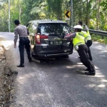 Beberapa petugas Satlantas Polres Pacitan saat membantu mendorong kendaraan yang tak kuat menanjak. 