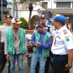 Plt. Kabid Parkir Dishub Kota Malang Musthaqim Jaya bersama tim gabungan menegur jukir di depan Stasiun Kota Baru agar menertibkan kendaraan agar tak menyebabkan kemacetan, Kamis (14/11). foto: IWAN IRAWAN/ BANGSAONLINE