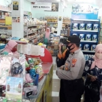 Personel gabungan Polres Pamekasan dan Satpol PP saat menyampaikan imbauan tentang physical distancing dan penggunaan masker di tempat umum.