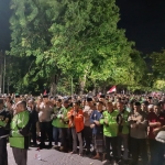 Driver Ojol saat mengelar Aksi solidaritas, tabur bunga hingga Sholat Ghoib di tengah Jalan Raya Pantura di depan Mapolres Pasuruan