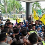 Aksi saling dorong antara mahasiswa PMII dan aparat keamanan saat demo di gedung DPRD Tuban. foto: GUNAWAN/ BANGSAONLINE