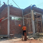 Nur Lailatul (kiri) Kepsek SDN Bandung 1 Gedeg sedang ikut memantu proses pembangunan perpustakaan.