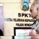 Polsek Wonoayu, Aiptu Dadang Purwadi saat merawat bayi korban KDRT di Mako setempat.