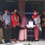 Kepala Dispendukcapil Jember, Isnaini Dwi Susanti, bersama dengan anak yatim penerima dokumen admindukcapil.