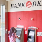Nasabah Bank DKI saat menggunakan ATM.
