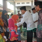 Wabup Setyo Hartono (baju putih) didampingi Kepala Desa Pucangarum, Sanawi (baju batik) saat menyerahkan santunan kepada anak yatim dan kaum dhuafa. foto: EKY NURHADI/ BANGSAONLINE